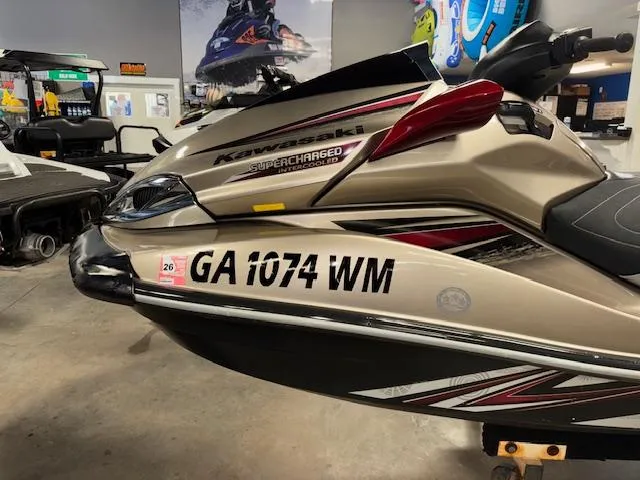 Slide: The Image of 2013 Kawasaki Ultra 300 LX jet ski in showroom, featuring supercharged engine and registration number GA 1074 WM. - 8