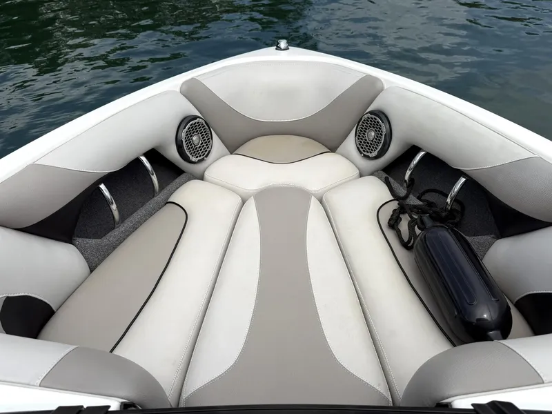 Slide: The Image of Interior of a 2012 Malibu 21 Ride boat with cushioned seating and speakers. - 12