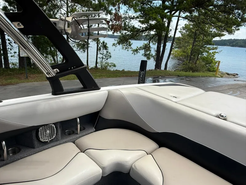 Slide: The Image of Interior of a 2012 Malibu 21 Ride boat with lake view and trees. - 15