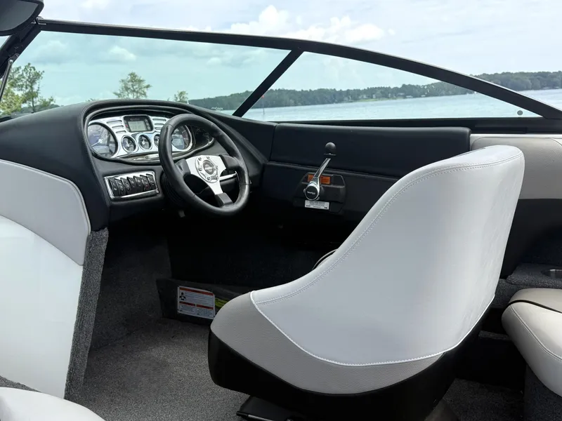 Slide: The Image of Interior of a 2012 Malibu 21 Ride boat with steering wheel and dashboard. - 9