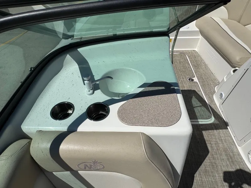 Slide: The Image of 2017 NauticStar 203 DC boat interior with sink and cup holders. - 10