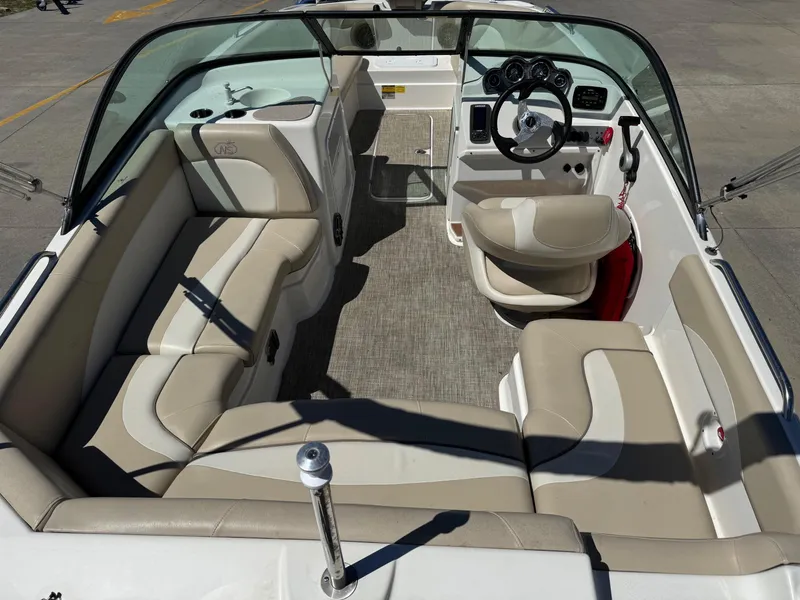 Slide: The Image of 2017 NauticStar 203 DC boat interior with beige seating and steering console. - 20
