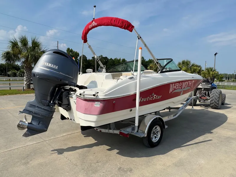 Slide: The Image of 2017 NauticStar 203 DC boat with Yamaha engine on trailer, parked outdoors. - 3