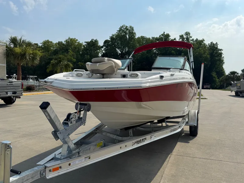 Slide: The Image of 2017 NauticStar 203 DC boat on trailer, red and white, parked outdoors. - 6