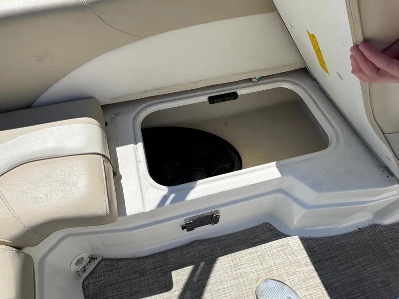 Slide: The Image of Open storage compartment in 2017 NauticStar 203 DC boat, featuring beige seating. - 9