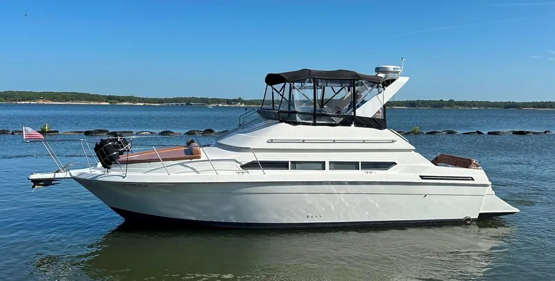 The Image of 1996 Carver 38 Santego yacht on calm water, clear sky background. - 0
