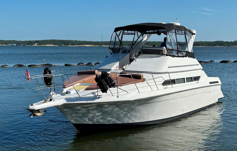 Slide: The Image of 1996 Carver 38 Santego yacht on calm water, clear sky, and scenic background. - 2