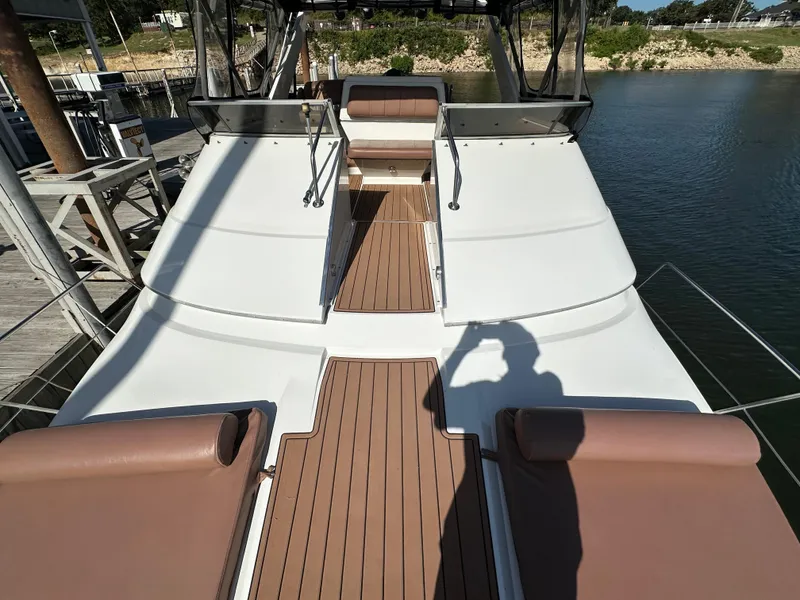 Slide: The Image of 1996 Carver 38 Santego yacht deck with brown seating and wooden flooring. - 22