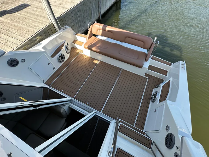 Slide: The Image of 1996 Carver 38 Santego boat deck with brown seating and wood-style flooring. - 24