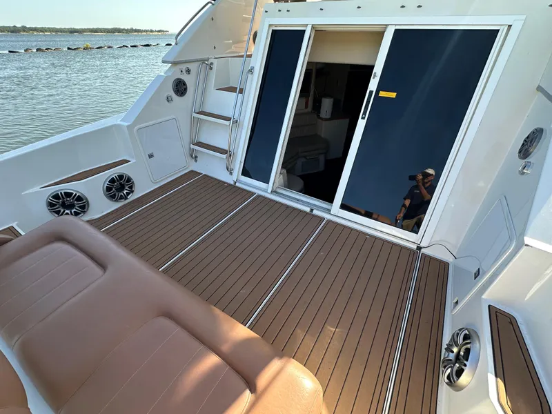Slide: The Image of 1996 Carver 38 Santego yacht deck with brown seating and sliding glass doors. - 29