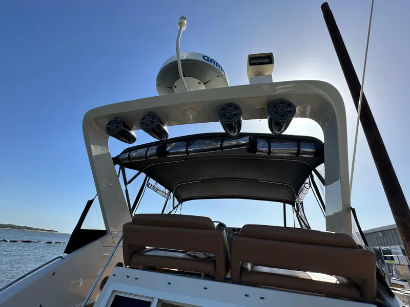 Slide: The Image of 1996 Carver 38 Santego yacht with radar and speakers, docked under clear blue sky. - 30
