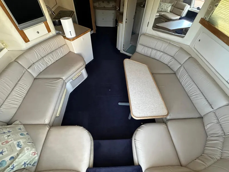 Slide: The Image of Interior of 1996 Carver 38 Santego yacht with beige leather seating and table. - 31