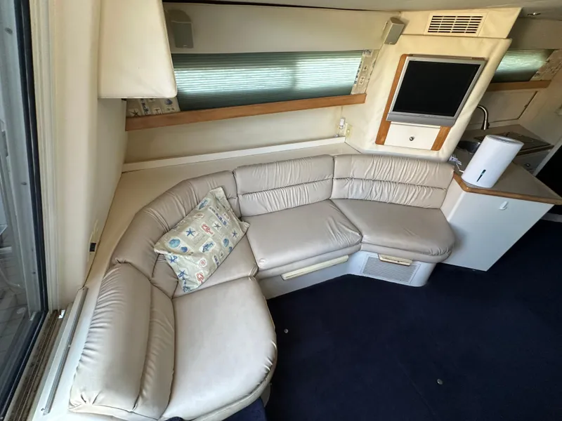 Slide: The Image of Interior of 1996 Carver 38 Santego yacht with beige leather seating and nautical-themed pillow. - 33