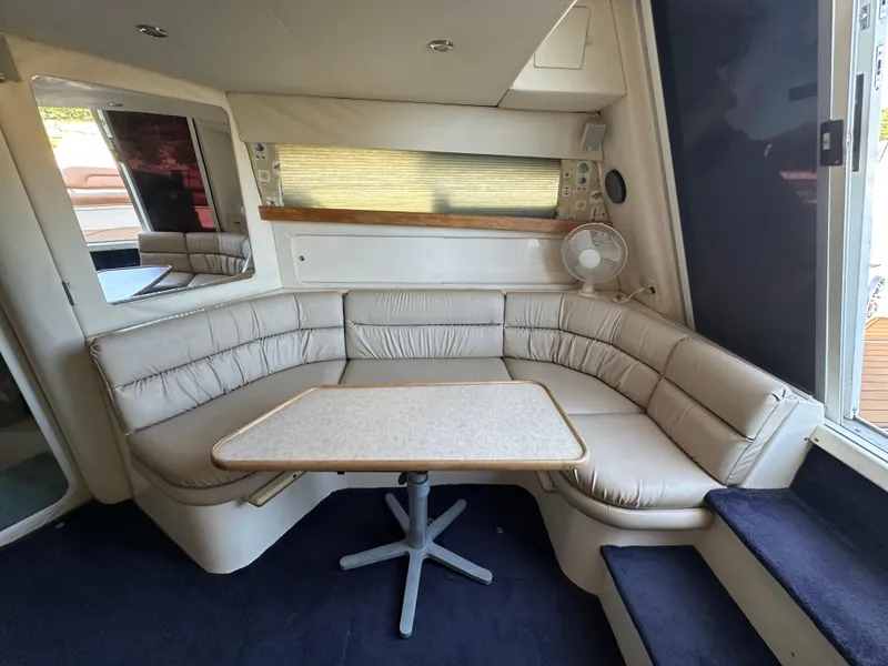 Slide: The Image of Interior of 1996 Carver 38 Santego yacht with beige seating and table. - 34