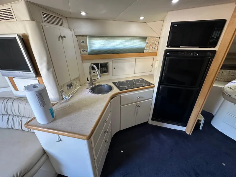 Slide: The Image of Interior of 1996 Carver 38 Santego yacht kitchen with appliances and seating area. - 36