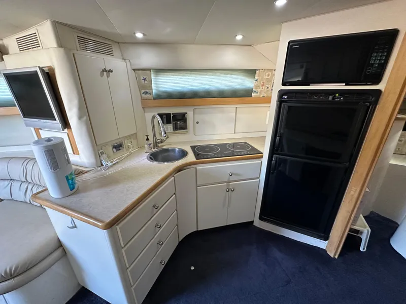 Slide: The Image of Interior of 1996 Carver 38 Santego yacht kitchen with appliances and seating area. - 37