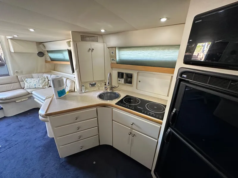Slide: The Image of Interior of 1996 Carver 38 Santego yacht with modern kitchen and seating area. - 42