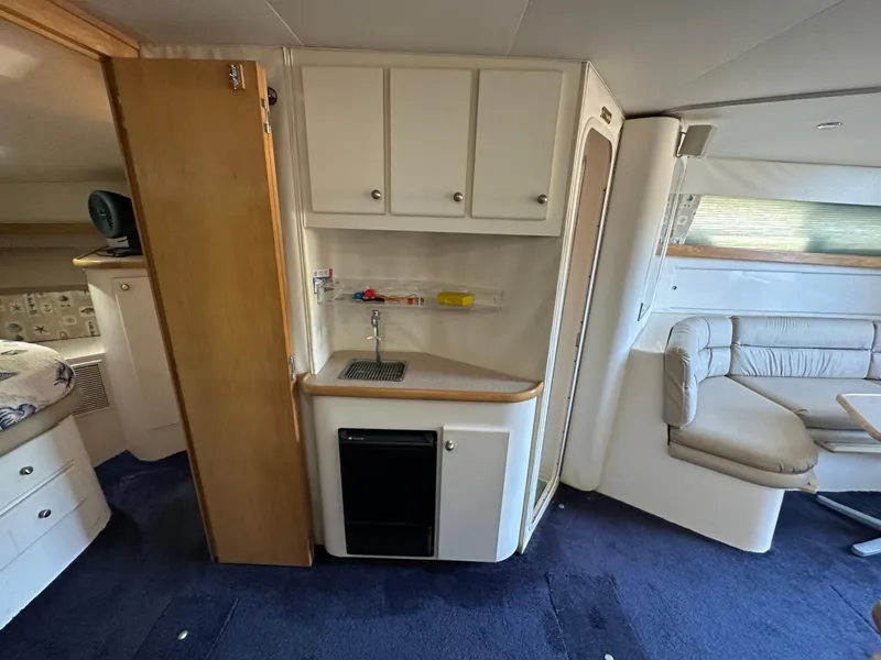 Slide: The Image of Interior of 1996 Carver 38 Santego yacht with kitchenette and seating area. - 43