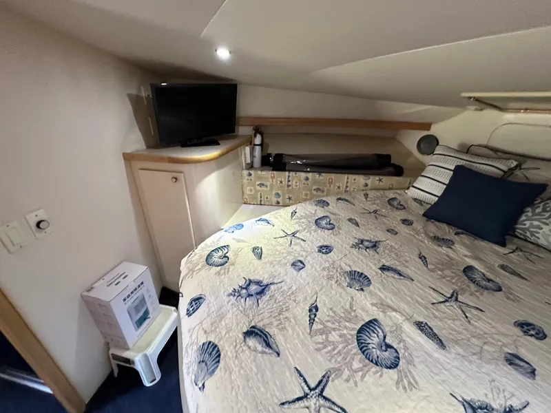 Slide: The Image of Cozy bedroom in 1996 Carver 38 Santego yacht with nautical-themed bedding. - 46