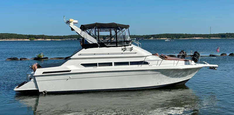 Slide: The Image of 1996 Carver 38 Santego yacht on calm water, featuring sleek design and spacious deck. - 9