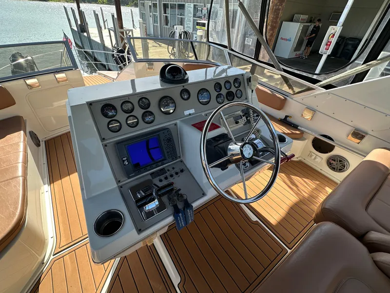 Slide: The Image of 1996 Carver 38 Santego boat helm with steering wheel and control panel. - 12