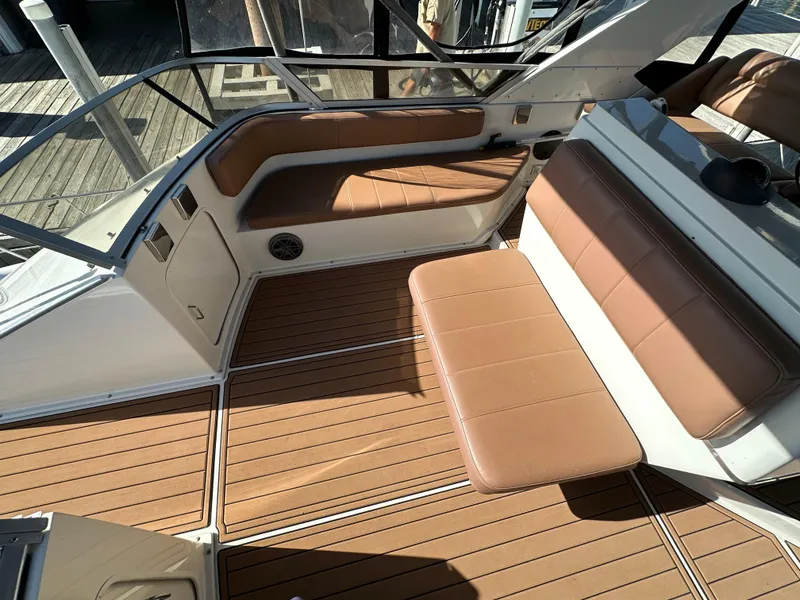 Slide: The Image of 1996 Carver 38 Santego boat interior with brown seating and wood-patterned flooring. - 17