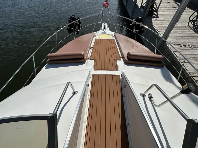 Slide: The Image of 1996 Carver 38 Santego yacht deck with cushioned seating and wooden flooring. - 18