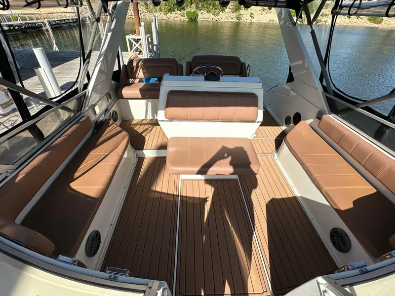 Slide: The Image of 1996 Carver 38 Santego boat interior with brown seating and wood flooring. - 23