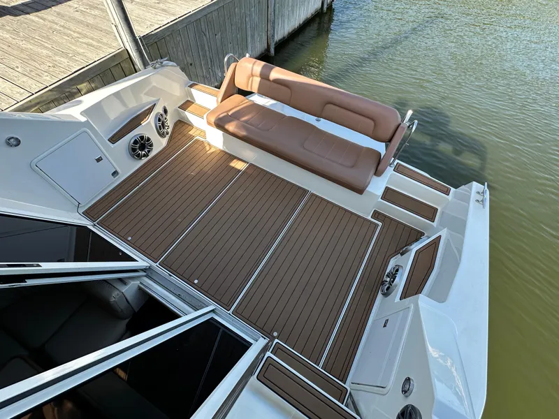 Slide: The Image of 1996 Carver 38 Santego boat deck with brown seating and wood-like flooring. - 25