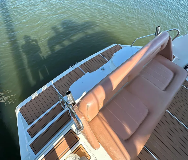 Slide: The Image of 1996 Carver 38 Santego boat deck with tan seating and wood accents. - 26