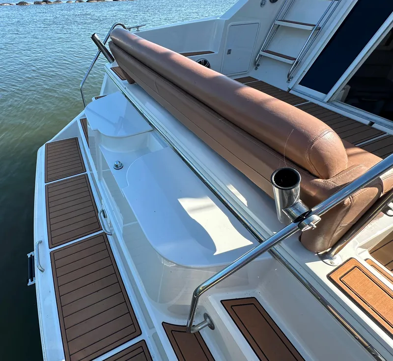 Slide: The Image of 1996 Carver 38 Santego boat deck with brown seating and wood accents by the water. - 27