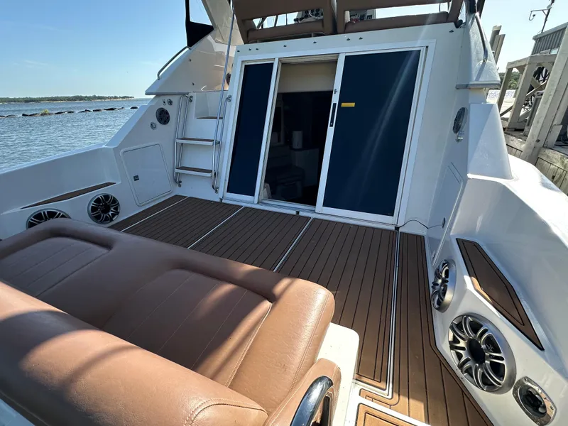 Slide: The Image of 1996 Carver 38 Santego yacht deck with brown seating and sliding doors. - 28
