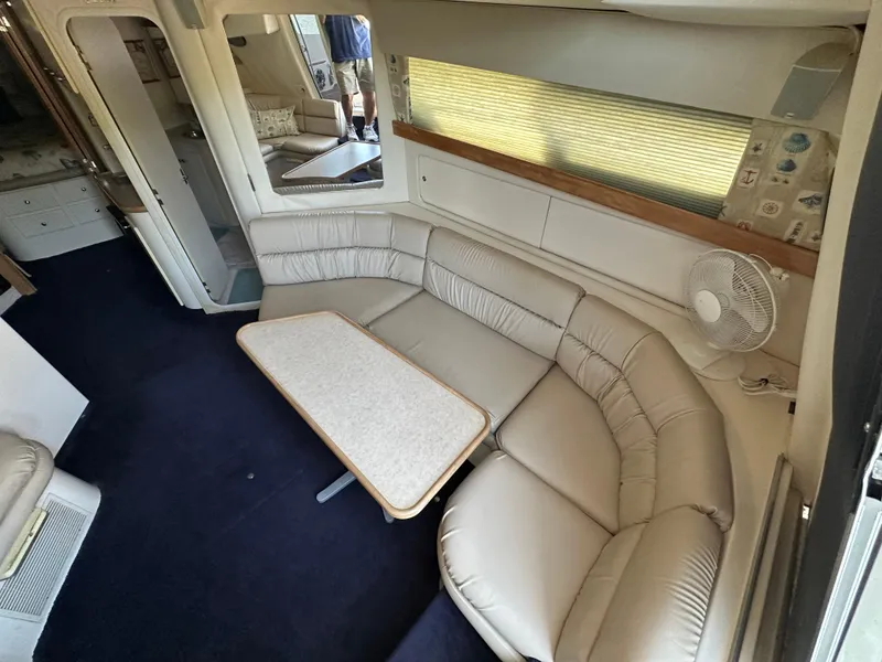 Slide: The Image of Interior of 1996 Carver 38 Santego yacht with beige seating and table. - 32