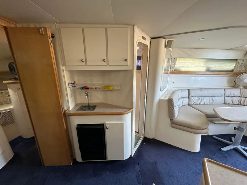 Slide: The Image of Interior of 1996 Carver 38 Santego yacht with kitchenette and seating area. - 39