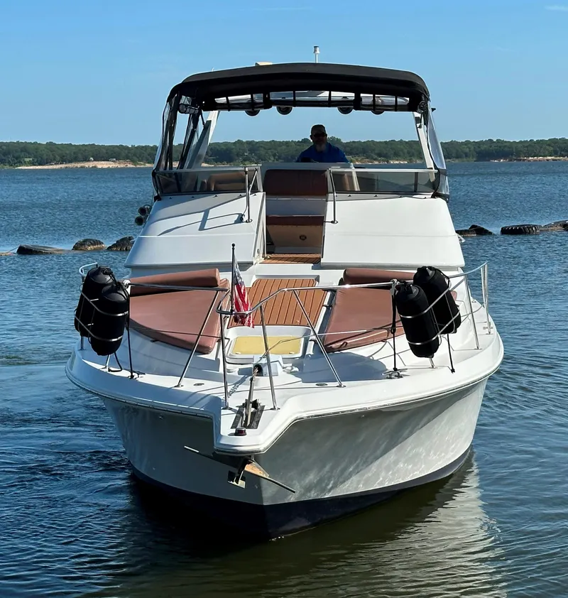 Slide: The Image of 1996 Carver 38 Santego yacht on calm water, front view. - 4