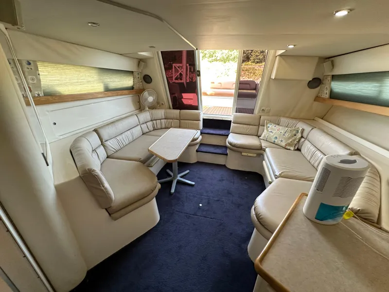 Slide: The Image of Interior of 1996 Carver 38 Santego yacht with beige seating and table. - 40