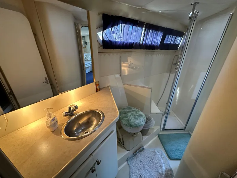 Slide: The Image of Bathroom interior of 1996 Carver 38 Santego yacht with sink, toilet, and shower. - 48