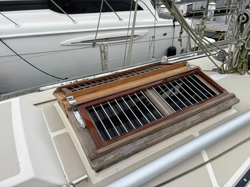 Slide: The Image of 1987 Ta Shing Tashiba 36 sailboat deck with wooden hatch and metal bars. - 10