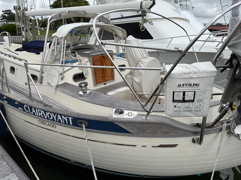 Slide: The Image of 1987 Ta Shing Tashiba 36 sailboat named "Clairvoyant" docked, featuring a Lifesling safety device. - 2