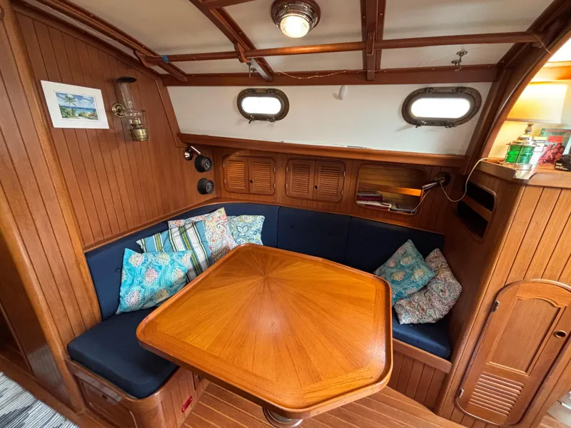 Slide: The Image of Cozy 1987 Ta Shing Tashiba 36 sailboat interior with wooden dining area and colorful cushions. - 20