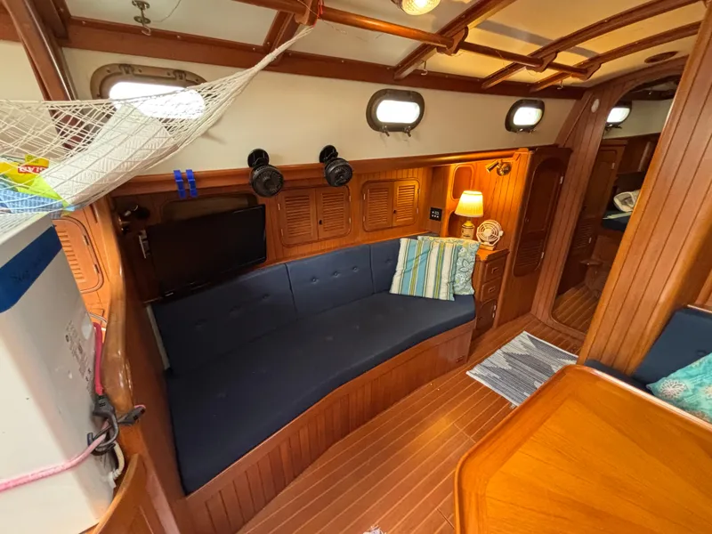 Slide: The Image of Cozy interior of 1987 Ta Shing Tashiba 36 sailboat with blue seating and wooden accents. - 24