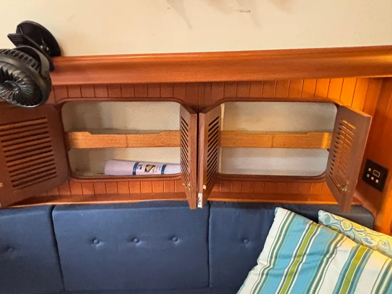 Slide: The Image of Wooden cabinet with open doors, blue cushions, and striped pillows on a 1987 Ta Shing Tashiba 36. - 26