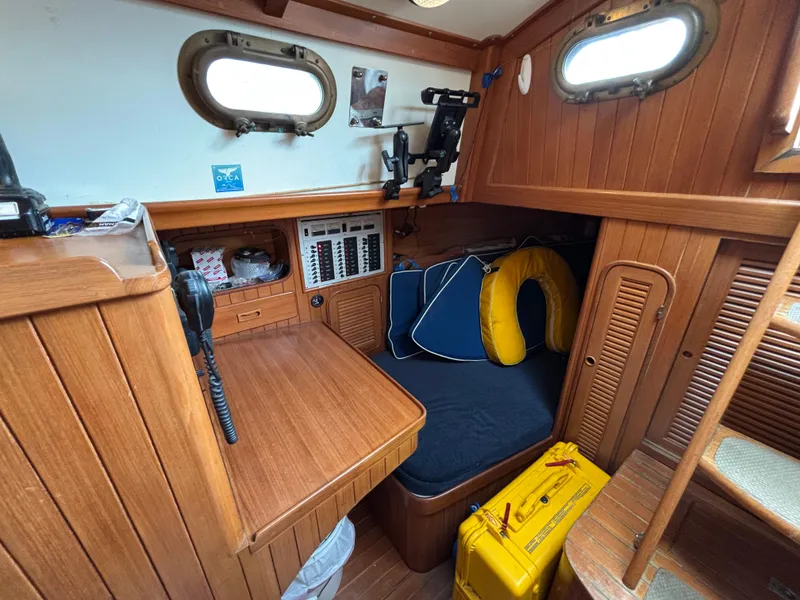 Slide: The Image of 1987 Ta Shing Tashiba 36 sailboat interior with wood paneling, navigation station, and portholes. - 27