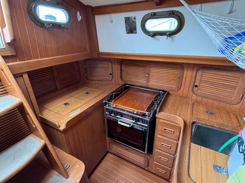Slide: The Image of 1987 Ta Shing Tashiba 36 yacht interior with wooden cabinetry and compact kitchen area. - 29