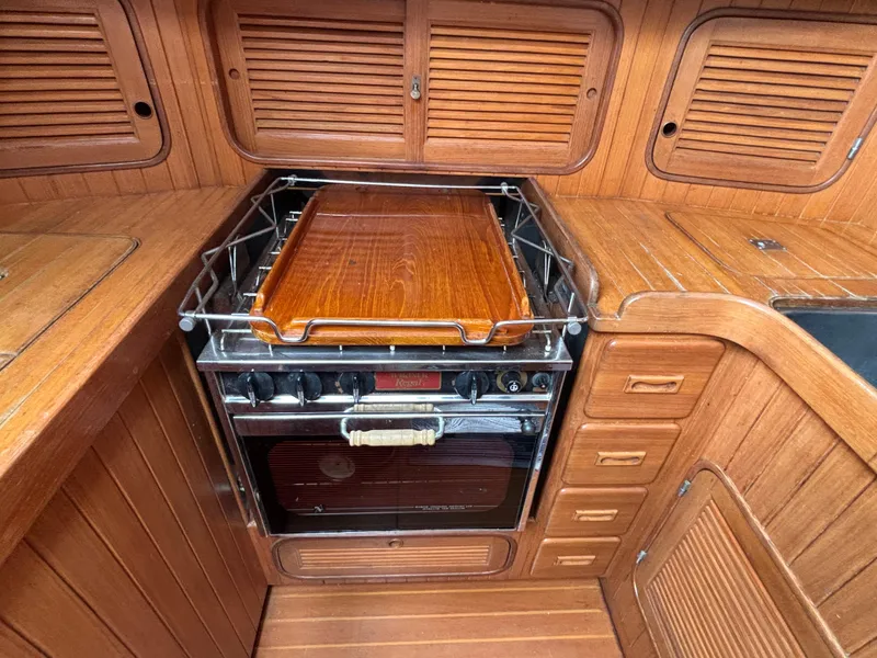 Slide: The Image of 1987 Ta Shing Tashiba 36 yacht kitchen with wooden cabinetry and stove. - 31