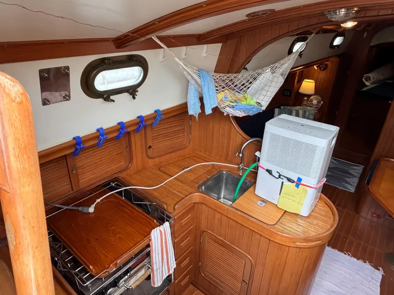Slide: The Image of 1987 Ta Shing Tashiba 36 yacht interior with wooden cabinetry and compact kitchen area. - 32
