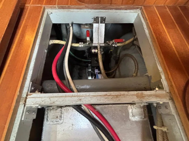 Slide: The Image of Engine compartment of 1987 Ta Shing Tashiba 36 sailboat with visible hoses and fittings. - 46