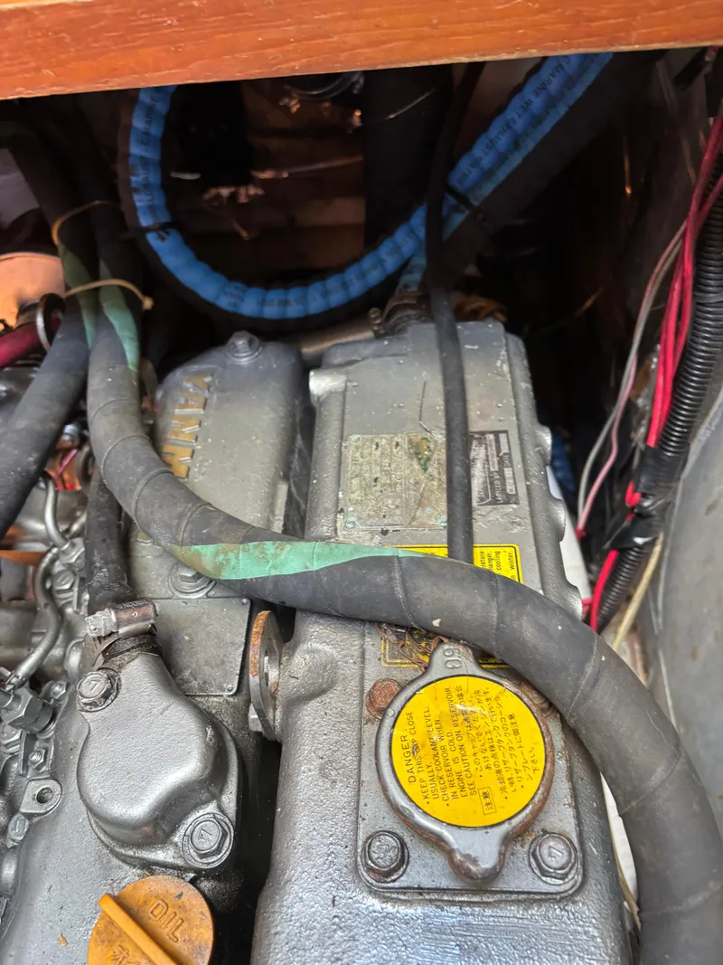 Slide: The Image of Engine compartment of a 1987 Ta Shing Tashiba 36 sailboat, showing hoses and components. - 48