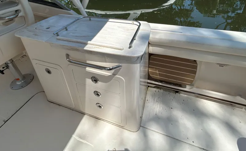 Slide: The Image of 2016 Grady-White Freedom 275 boat interior with storage compartments and seating. - 11