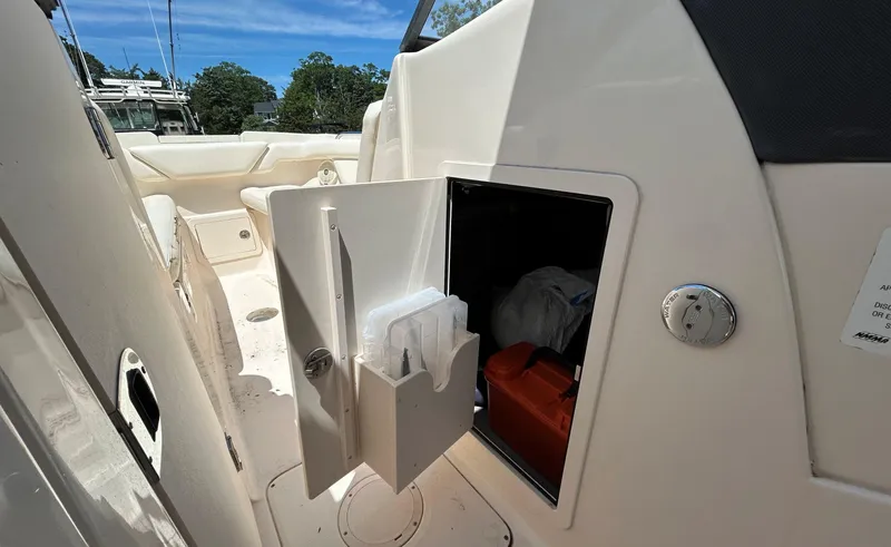 Slide: The Image of 2016 Grady-White Freedom 275 boat interior with open storage compartment. - 17
